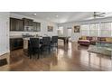 Open-concept living space with a modern kitchen island, pool table, and comfortable leather sofa at 5512 Cascade Sw Run, Atlanta, GA 30336
