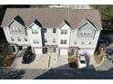 Overhead view of three-story townhomes showing roof lines, driveways, and surrounding landscaping at 951 Plaza Park Walk # 50, Kennesaw, GA 30144