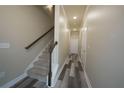 Hallway with hardwood flooring, stairway with carpet, and doors at 951 Plaza Park Walk # 50, Kennesaw, GA 30144