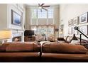 Inviting living room boasts a fireplace, tall windows, and comfortable seating arrangements at 955 Golf View Ct, Dacula, GA 30019