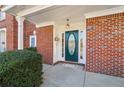 Close up of the front door and porch with brick facade at 2075 Pine Tree Dr # D4, Buford, GA 30518