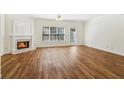 Spacious living room featuring a cozy fireplace and abundant natural light at 2075 Pine Tree Dr # D4, Buford, GA 30518