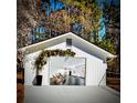 A spacious detached garage with a decorated entrance, providing a glimpse into a cozy living space at 5079 N Dogwood Hills Dr, Buford, GA 30518