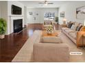 Bright, virtually staged living room with fireplace, wood floors and neutral decor at 807 Ambient Sw Way, Atlanta, GA 30331