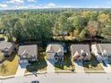 Aerial shot of charming neighborhood with lush trees, showcasing homes with manicured lawns and inviting curb appeal at 1118 Reddy Farm Rd, Grayson, GA 30017