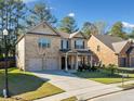 Two story brick home with well maintained lawn and landscaping, two-car garage, and a covered front entrance at 1118 Reddy Farm Rd, Grayson, GA 30017