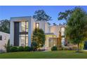 Modern home exterior at twilight featuring lush lawn and ample natural lighting at 1260 Brook Forest Ne Dr, Atlanta, GA 30324