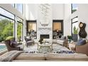 Bright living room featuring high ceilings, floor to ceiling windows and stylish decor at 1260 Brook Forest Ne Dr, Atlanta, GA 30324