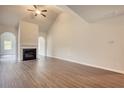 Living room with a fireplace, vaulted ceilings, and an archway into another room at 700 Park Place Way, Social Circle, GA 30025