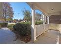 Inviting front porch with white pillars and railing offers a relaxing outdoor space at 1150 Strath Clyde Way, Mcdonough, GA 30253