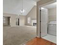 Bright and airy living room with a fireplace, high ceilings, and easy access to the laundry room at 1150 Strath Clyde Way, Mcdonough, GA 30253