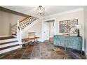 Warm foyer with slate tile, staircase, decorative mirror, and a vintage accent table at 501 Brook Hollow Se Cir, Marietta, GA 30067