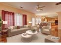 An open-concept living area with ample seating, flowing into dining and kitchen at 1225 Sand Knoll Sw Run, Lilburn, GA 30047