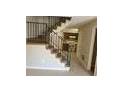 View of the staircase with metal railing leading to the kitchen at 2627 Evans Mill Dr, Lithonia, GA 30058