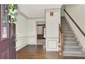 Entryway featuring hardwood floors, staircase, neutral walls, and decorative trim at 4314 Deep Springs Nw Ct, Kennesaw, GA 30144