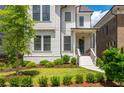 Inviting two-story home featuring a charming front porch and well-manicured landscaping at 720 Tannery Cmn, Alpharetta, GA 30009
