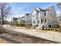 Attractive two-story white home with dark roof and a well-maintained front yard and sidewalk in a lovely neighborhood at 720 Tannery Cmn, Alpharetta, GA 30009