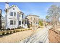 A beautiful white two-story home with manicured lawn and sidewalk in a picturesque neighborhood at 720 Tannery Cmn, Alpharetta, GA 30009