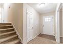 Inviting entryway with neutral paint, a front door with glass, and stairs leading to the upper level at 3585 Ale Cir, Atlanta, GA 30344