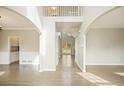 Bright foyer features hardwood floors, neutral walls, soaring ceilings, an open floor plan, and recessed lighting at 4074 Gold Mill Rdg, Canton, GA 30114