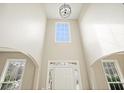 Entryway featuring soaring ceilings with large windows, letting in natural light and highlighting the open floor plan at 4074 Gold Mill Rdg, Canton, GA 30114