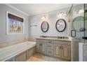 Modern bathroom with double sinks, granite counters, a soaking tub, and a glass-enclosed shower at 160 Alpine Dr, Roswell, GA 30075