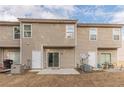Back exterior featuring a sliding glass door and cozy patio space at 1732 Broad River Rd, Atlanta, GA 30349