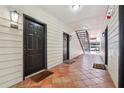 Hallway with neutral wall paint, tile flooring, and staircase leading to the parking area at 3777 Peachtree Ne Rd # 911, Atlanta, GA 30319
