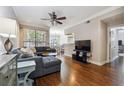 Cozy living room with dark hardwood floors, a comfortable gray sofa, and bright windows at 3777 Peachtree Ne Rd # 911, Atlanta, GA 30319