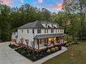 Stunning two-story home with a covered porch, manicured landscaping, spacious driveway and attached garage at 650 Jones Rd, Roswell, GA 30075