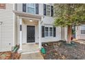Close up on house exterior, featuring a front door with classic columns and a small garden at 745 Crestwell Sw Cir, Atlanta, GA 30331