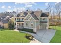 Beautiful two-story home with a lush green lawn, long driveway, and attached two-car garage at 2952 Perimeter Cir, Buford, GA 30519
