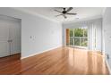 A bedroom offering hardwood floors, a ceiling fan, and a sliding glass door for balcony access at 10 Perimeter Summit Ne Blvd # 4312, Atlanta, GA 30319