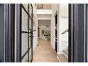 Bright foyer with black framed glass door, hardwood floors, and views into the living spaces at 198 Johnson Ferry Nw Rd, Atlanta, GA 30328