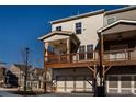 Back exterior showing deck overlooking garage of a three-story townhome with sidewalks at 504 Sonata Walk, Marietta, GA 30067