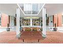 Inviting building entrance with a well-maintained brick walkway and park bench at 130 26Th Nw St # 511, Atlanta, GA 30309