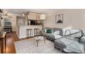 Inviting living room with hardwood floors, gray sofa, and an open kitchen at 2232 Dunseath Nw Ave # 302, Atlanta, GA 30318