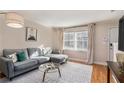 Bright living room featuring a comfortable gray sectional sofa and hardwood floors at 2232 Dunseath Nw Ave # 302, Atlanta, GA 30318