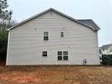 The back exterior of the home shows neutral siding and several windows at 114 Crescent Woode Way, Dallas, GA 30157