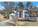 Charming home featuring a gazebo, stucco siding, blue trim, attached garage, and landscaped front yard at 624 Longbow Ct, Stone Mountain, GA 30087