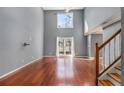 Spacious living room with high ceilings, hardwood floors, a ceiling fan and a staircase at 624 Longbow Ct, Stone Mountain, GA 30087