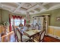 Elegant dining room featuring a chandelier, decorative ceiling, and formal dining set with seating for six at 85 Tanglewood Dr, Covington, GA 30016