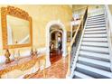 Grand foyer with ornate mirror, staircase and hardwood floors and archway at 85 Tanglewood Dr, Covington, GA 30016