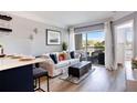 Living room with a balcony access featuring an ottoman, area rug, and comfortable seating with many throw pillows at 275 13Th St # Apt 509, Atlanta, GA 30309