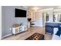 Open living room with hardwood floors, built in shelving, and modern furnishings next to the kitchen at 275 13Th St # Apt 509, Atlanta, GA 30309