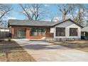 Charming bungalow-style home with painted white brick, attached garage, and a well-manicured front lawn at 3080 Hamilton Rd, Decatur, GA 30032