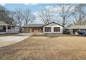 Charming bungalow-style home with painted white brick and attached garage at 3080 Hamilton Rd, Decatur, GA 30032