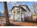 Beautiful exterior showcasing the covered front porch of this newly built home, plus yard with wood fencing at 1986 Memorial Se Dr, Atlanta, GA 30317