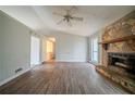 Open living room layout with laminate flooring and a stone fireplace at 3500 Quail Hollow Trl, Snellville, GA 30039