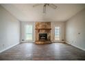 Living room featuring a stone fireplace, laminate flooring, and neutral paint at 3500 Quail Hollow Trl, Snellville, GA 30039
